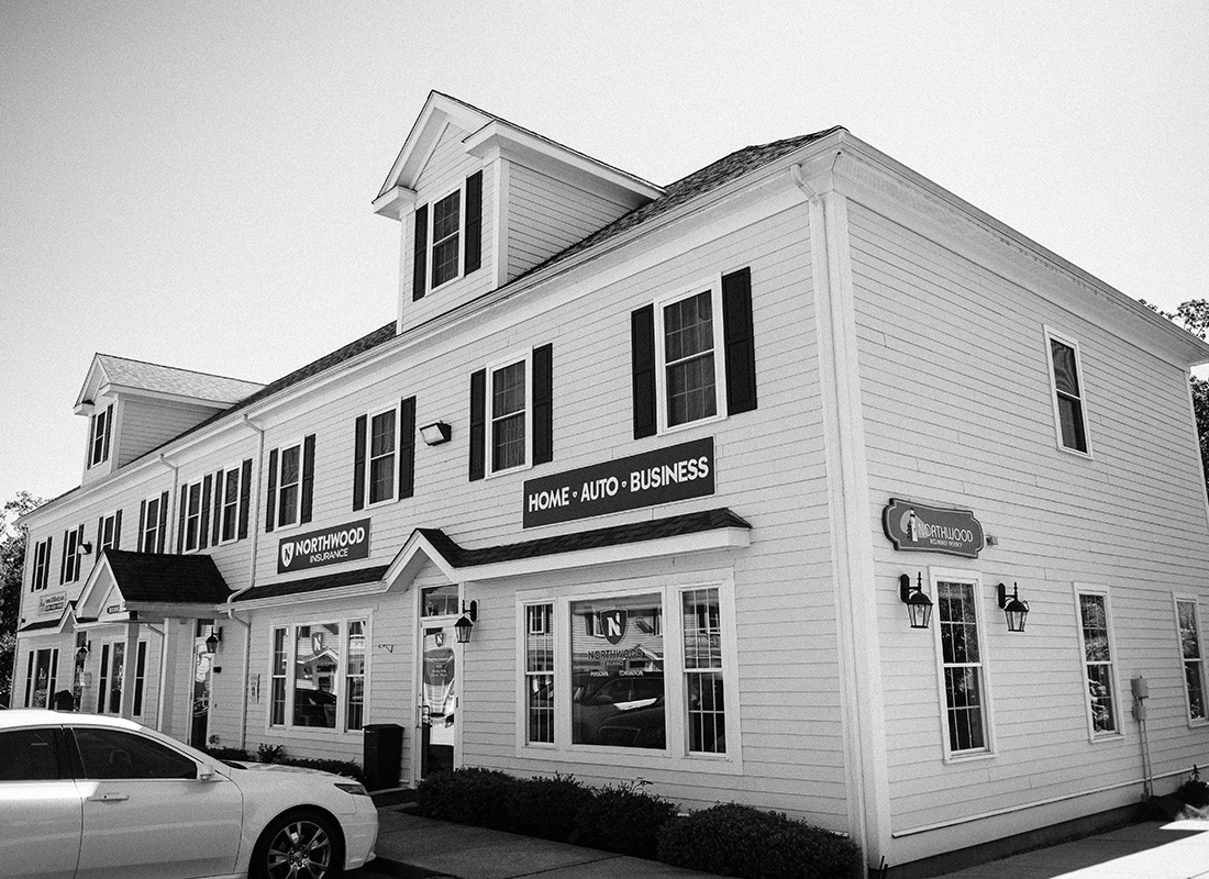 Northborough, MA - Black and White Photo of the Exterior of the Northwood Insurance Agency Office Building with a Car Parked in the Front